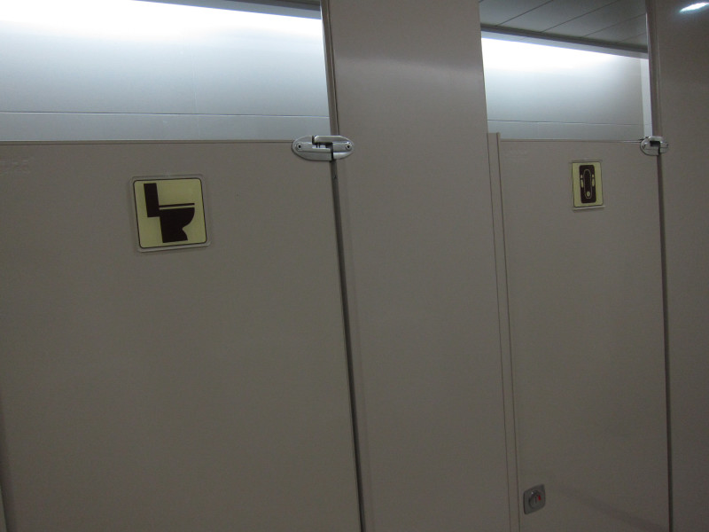 Simple, useful signage on washroom doors at Chongqing Airport